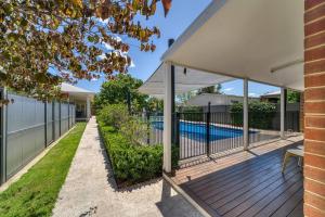 an outdoor deck with a pool in a house at Stay at beautiful Rea in Shepparton