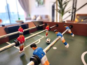 a group of toy people playing a game of soccer at Loft Suite CityView near JB CIQ 7Pax in Johor Bahru