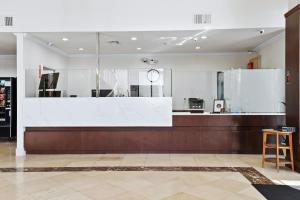 a lobby with a white counter and a kitchen at Brookhurst Plaza Inn in Anaheim