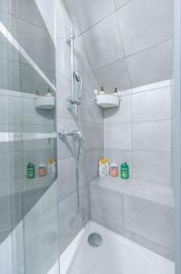 a white bathroom with a shower and a tub at Le Petit Tremblay at 10 min Parc des Expos / CDG in Tremblay En France
