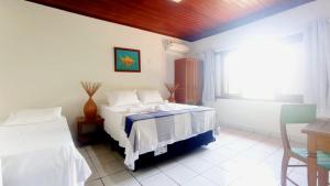 Ein Bett oder Betten in einem Zimmer der Unterkunft Machê Pousada & Boutique - A mais charmosa de Arraial D ajuda