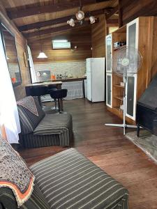 ein Wohnzimmer mit einem Sofa und einer Küche in der Unterkunft Cabaña eluney in Ocean Park