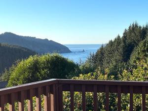 a wooden deck with a view of the ocean at Cottage by the Sea in Carpenterville