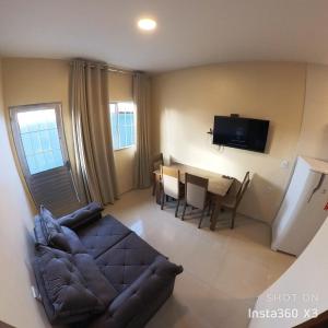 a living room with a couch and a dining room at Recanto dos Amigos in Santo Amaro +14 photos