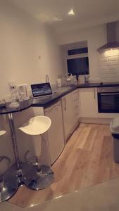a kitchen with a table and a laptop on a counter at Northampton Central Oasis in Northampton