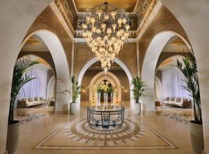 a large lobby with a chandelier and a table at Steigenberger Alcazar in Sharm El Sheikh