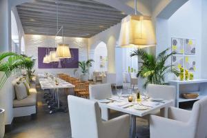 a dining room with white tables and white chairs at Steigenberger Alcazar in Sharm El Sheikh