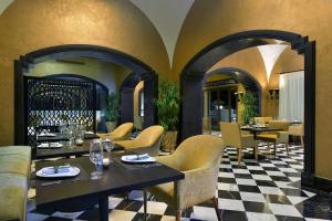 a restaurant with tables and chairs and a checkered floor at Steigenberger Alcazar in Sharm El Sheikh