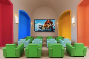 a room with chairs and a tv on the wall at Steigenberger Alcazar in Sharm El Sheikh