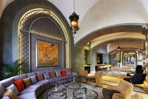 a living room with a purple couch and chairs at Steigenberger Alcazar in Sharm El Sheikh