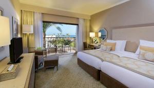a hotel room with a large bed and a balcony at Steigenberger Alcazar in Sharm El Sheikh