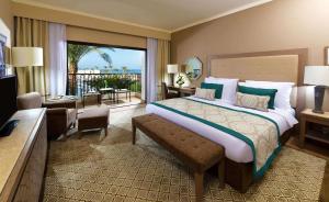 a hotel room with a large bed and a balcony at Steigenberger Alcazar in Sharm El Sheikh