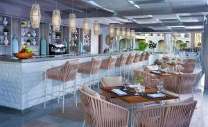 a restaurant with tables and chairs and a bar at Steigenberger Alcazar in Sharm El Sheikh