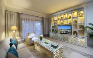 a living room with a couch and a tv at Steigenberger Alcazar in Sharm El Sheikh