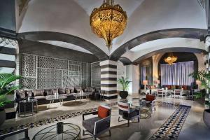 a lobby with couches and tables and a chandelier at Steigenberger Alcazar in Sharm El Sheikh