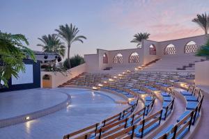 an empty amphitheater with rows of chairs and a stage at Steigenberger Coraya Beach - Adults Friendly 16 Years Plus in Coraya Bay