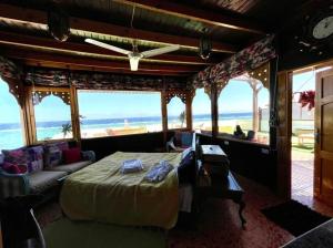 a bedroom with a bed and a view of the beach at hakuna matata in Dahab