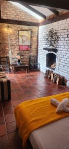 a room with a brick wall and a fireplace at Mitanni in Santa Isabel