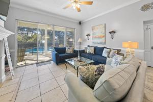 a living room with blue couches and a fireplace at Sea-renity Home in Sunnyside