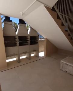 een trap in een huis met een plafond met verlichting bij Pousada Provinelli in Palhoça