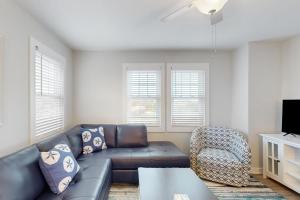 a living room with a couch and a chair at Scallop in Buxton