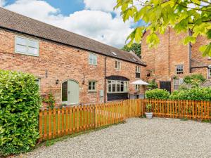 a brick house with a fence in front of it at 3 Bed in Church Stretton 76621 in Rushbury