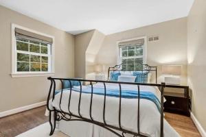 a bedroom with a bed and two windows at LUX Entire home in Bethesda RARE in Bethesda