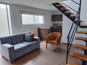 ein Wohnzimmer mit Sofa und Treppe in der Unterkunft JOMAWA Vivienda Turística in Guayabal