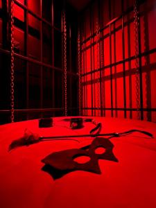 a red room with a bed with a demon on it at Dubai VIP Motel in Bogotá