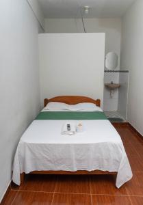 a bedroom with a bed with a tray on it at Hospedaje Humazapa Tarapoto, San Martín in Tarapoto