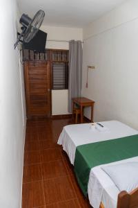 a hotel room with a bed and a fan at Hospedaje Humazapa Tarapoto, San Martín in Tarapoto