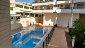 a swimming pool in front of a building at Plaza Mayor 2 bedroom Apartment in Calpe