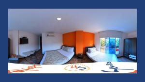 a hotel room with two beds and a window at Hotel Sevilla Neiva in Neiva