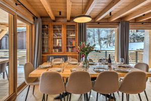 a dining room with a table and chairs at Chalet Belle des Neiges - Alpes Travel - Sleeps 9 in Les Houches