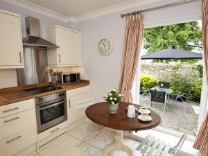 a kitchen with a wooden table and a table at 2 Bed in Hutton Magna G0116 in Hutton Magna