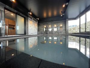 a large swimming pool in a building at Kotohira Park Hotel in Kotohira