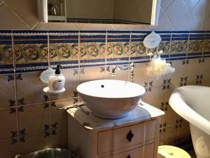 a bathroom with a bowl sink on a cabinet at Charmante maison historique avec jardin à Vadelaincourt - Charme, cheminée, et sérénité - FR-1-585-67 in Vadelaincourt +20 photos