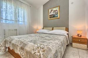 a bedroom with a bed and a window at Apartments by the sea Kastel Stafilic, Kastela - 21981 in Kastel Stafilic