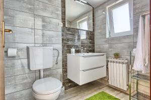 a bathroom with a toilet and a sink at Apartments by the sea Kastel Stafilic, Kastela - 21981 in Kastel Stafilic