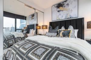 a bedroom with two beds and a large window at Australia 108 Palazzo Glam Luxury Apt Near Crown in Melbourne