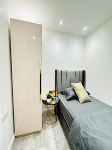 a bedroom with a bed and a side table at Studio 12 in London
