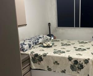 a stuffed animal laying on top of a bed at Apartamento Tupa in Propriá