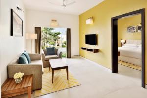 a living room with a couch and a bed at Four Points by Sheraton Mahabalipuram Resort & Convention Center in Mahabalipuram