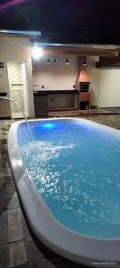 a large swimming pool with a water fountain at Casa da Lu in Barretos