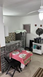 Habitación con mesa y mantel rojo y blanco en Apartamento Itanhanhem en Itanhaém