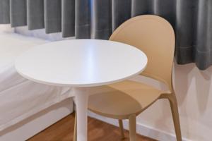 a white table and a chair next to a window at Hotel gongjicheon 2 in Chuncheon