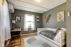 a bedroom with a bed and a desk and a window at Pet-Friendly Wilmington Retreat with Hot Tub! in Wilmington