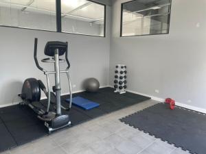 a room with a gym with a treadmill and weights at Palermo Apartamento Buenos Aires in Buenos Aires