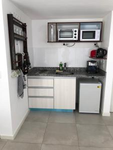 a kitchen with a sink and a microwave at Palermo Apartamento Buenos Aires in Buenos Aires