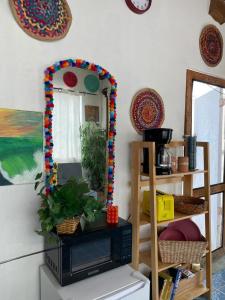 a living room with a mirror and a television at Beach Bungalow in Rosarito